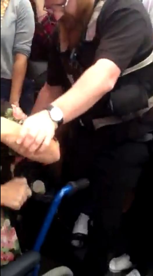 Onlookers are left shocked as the four bouncers bend down to pick up Anna's wheelchair