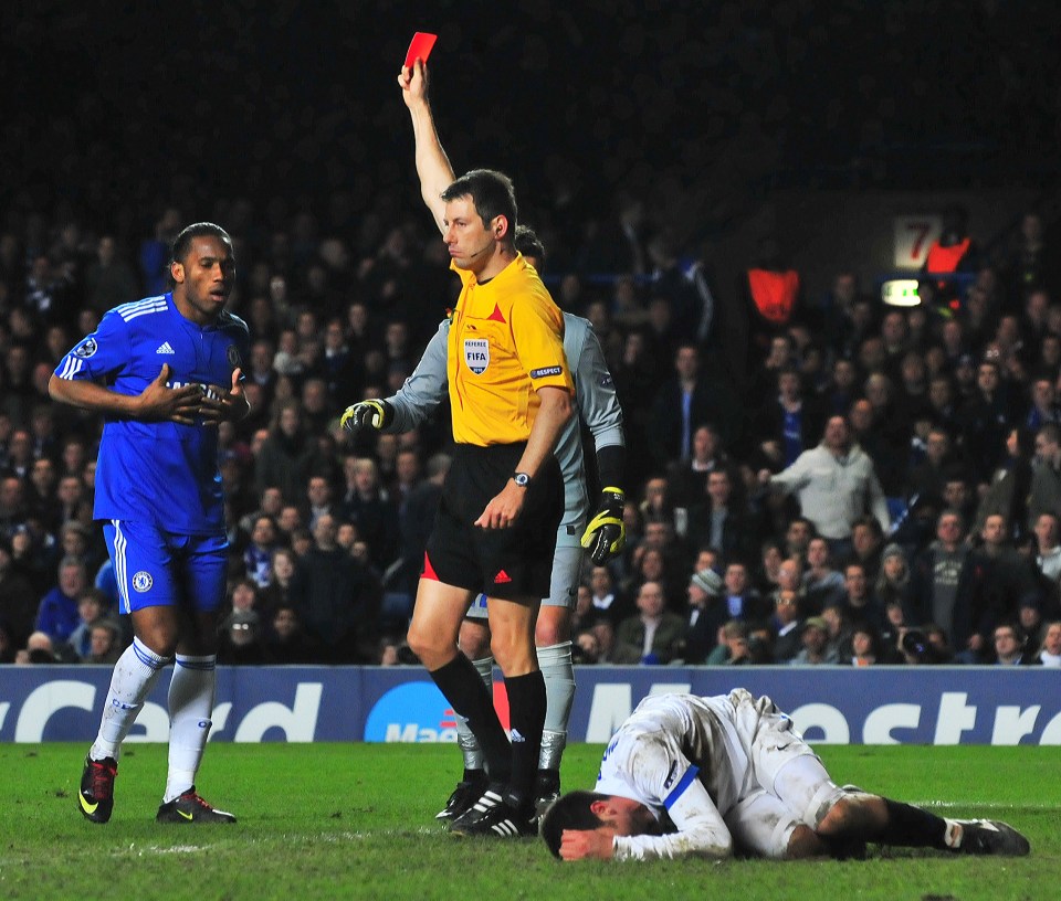 Chelsea's Ivorian striker Didier Drogba (L) is given a red card by match referee Wolfgang Stark (C) after a foul on Inter Milan's Brazilian midfielder Thiago Motta (R) during their second leg in the round of 16 UEFA Champions League match at home to Chelsea at Stamford Bridge football stadium, London on March 16, 2010. AFP PHOTO/Carl de Souza (Photo credit should read CARL DE SOUZA/AFP/Getty Images)