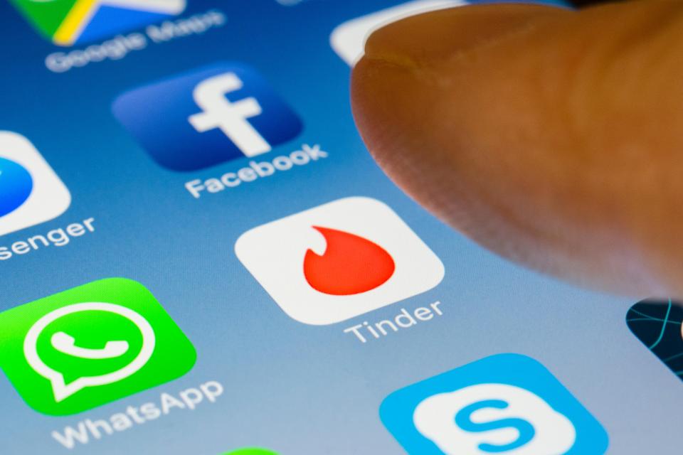 Tinder online dating app close up on iPhone smart phone screen