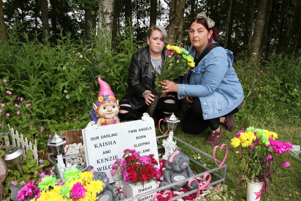  Katie McAllister and Lisa place flowers at Lisa's children's, Kaisha and Kenzie, grave at Birkhill cemetery