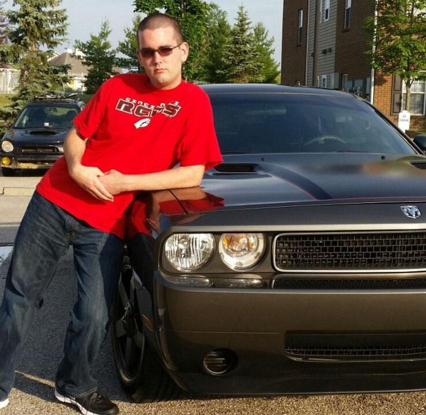  Fields (pictured posing next to the Challenger he used in the attack) was arrest by police a few blocks away from the bloody scene