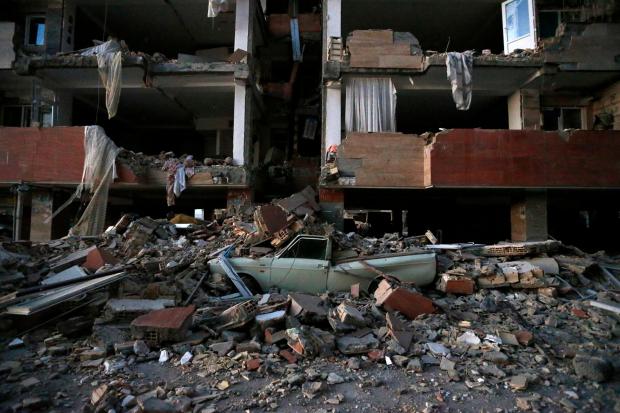 A car is smashed by debris from the earthquake at the city of Sarpol-e-Zahab in western Iran