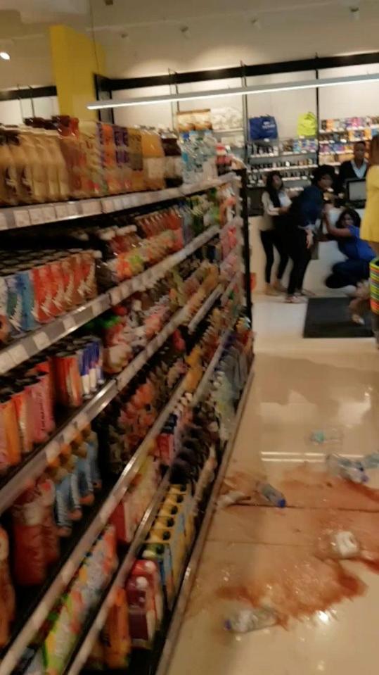 Bottles fall off a shelf and shatter to the floor as tremors are felt in San Fernando, in Trinidad and Tobago