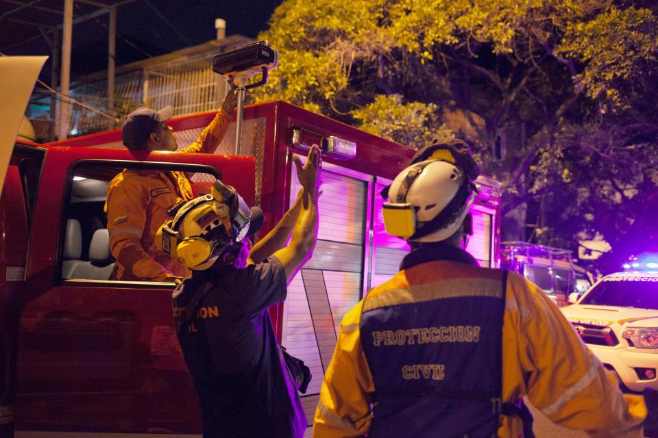Fire crew assess the Tower of David skyscraper which the quake almost tore apart