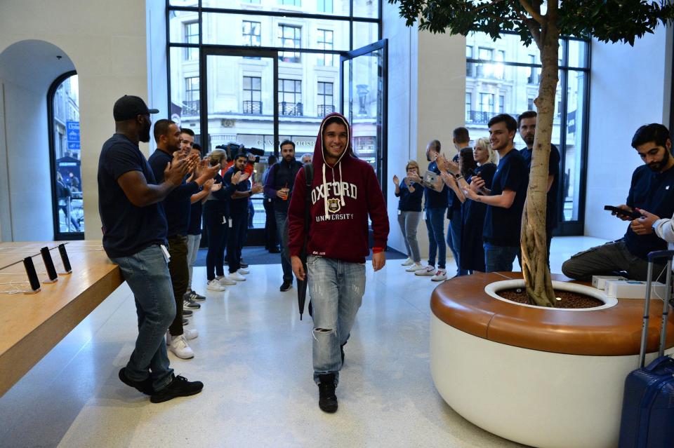 The first customers enter the Apple Store