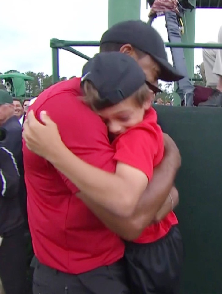  Woods hugs son Charlie after winning the Masters