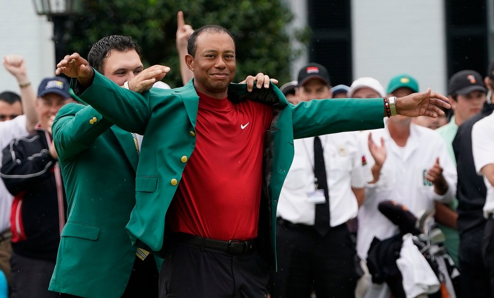 Last year's winner Patrick Reed puts the green jacket on Woods