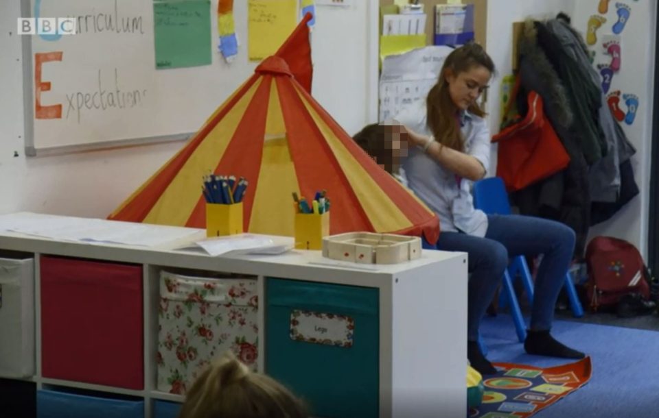  A five-year-old girl spits at another teacher, who is using the "positive handling" technique