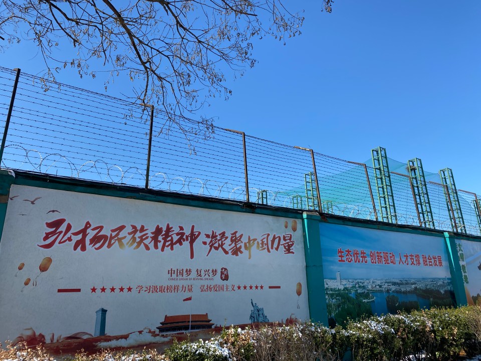 The fences along the side of the Qingdao Taekwang Shoes Co. factory