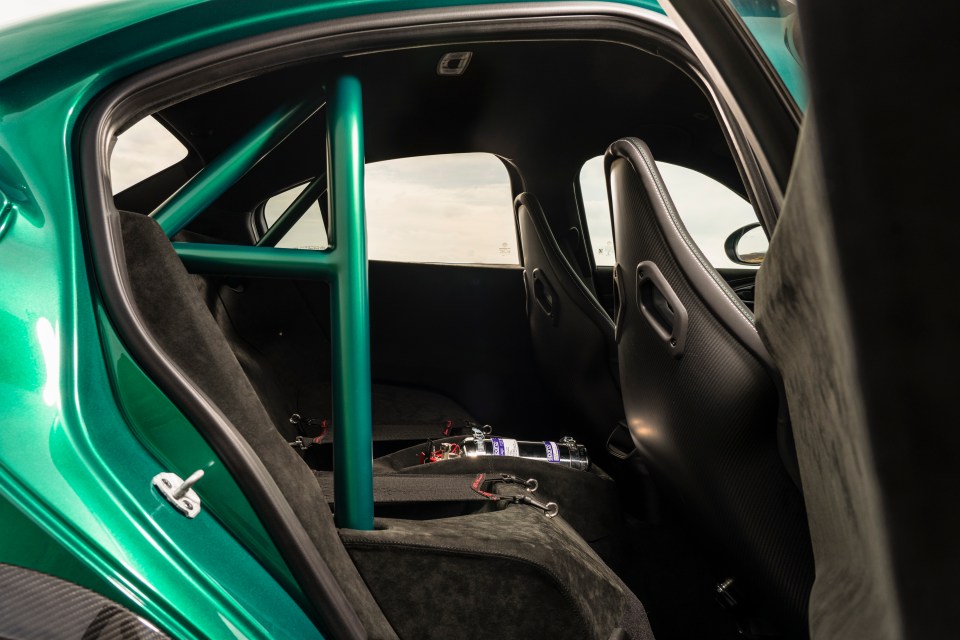 Big rear wing, single-nut wheels like an F1 car, wider track, aero tweaks by Sauber, polycarbonate rear windows, carbon-fibre everything, and a roll cage