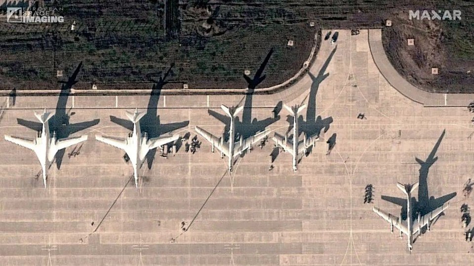Aerial view of several military aircraft on a tarmac.