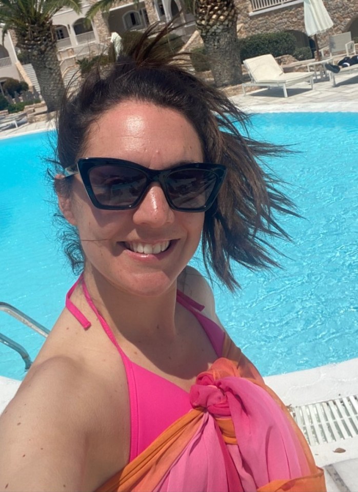 She posed in a bikini with a wrap around her during her windy holiday