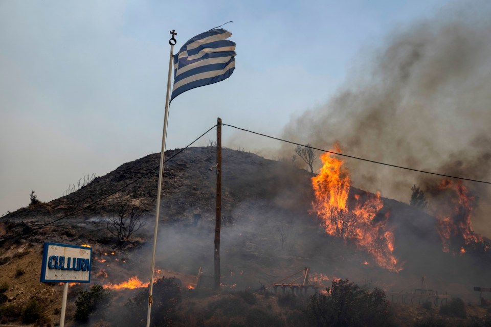 Flames burn a hill in Rhodes as Greece issues a level 5 wildfire alert for Crete