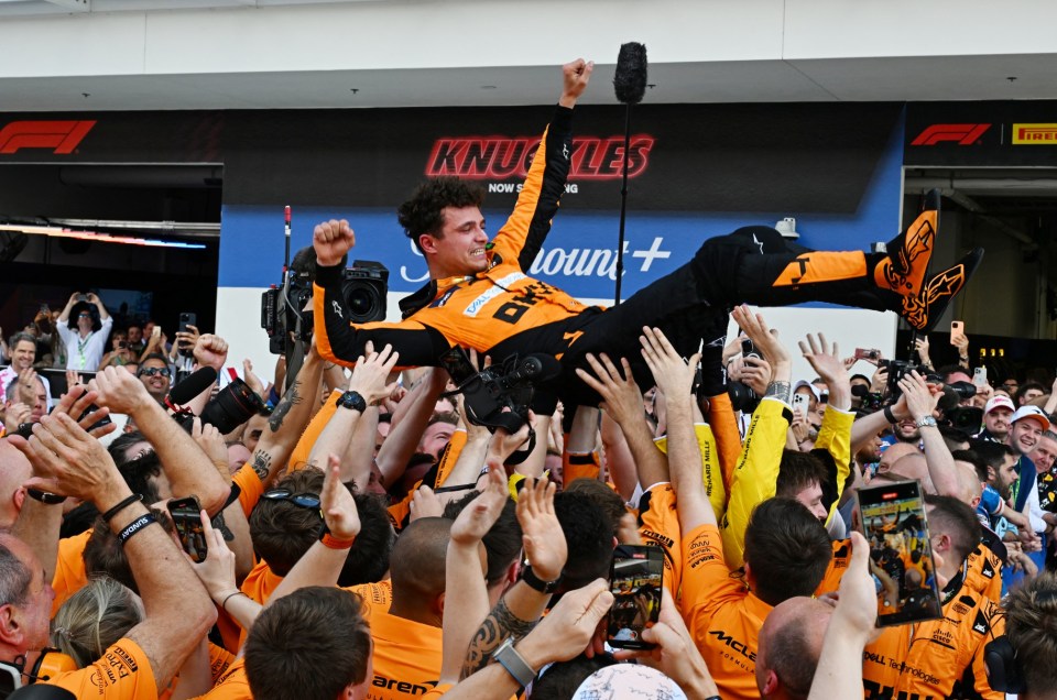 McLaren's British driver Lando Norris is tossed in the air as his team celebrates his victory in the 2024 Miami Formula One Grand Prix at Miami International Autodrome in Miami Gardens, Florida, on May 5, 2024. (Photo by Giorgio Viera / AFP) (Photo by GIORGIO VIERA/AFP via Getty Images)