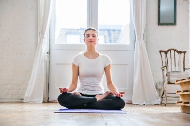 Woman meditating in lotus position.