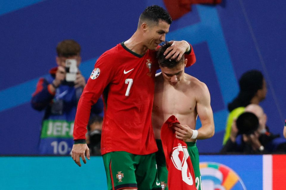 LEIPZIG, GERMANY - JUNE 18: Cristiano Ronaldo (L) of Portugal hugs teammate Francisco Conceicao to celebrate after the winning goal during the UEFA EURO 2024 group stage match between Portugal and Czechia at Football Stadium Leipzig on June 18, 2024 in Leipzig, Germany. (Photo by Richard Sellers/Sportsphoto/Allstar via Getty Images)