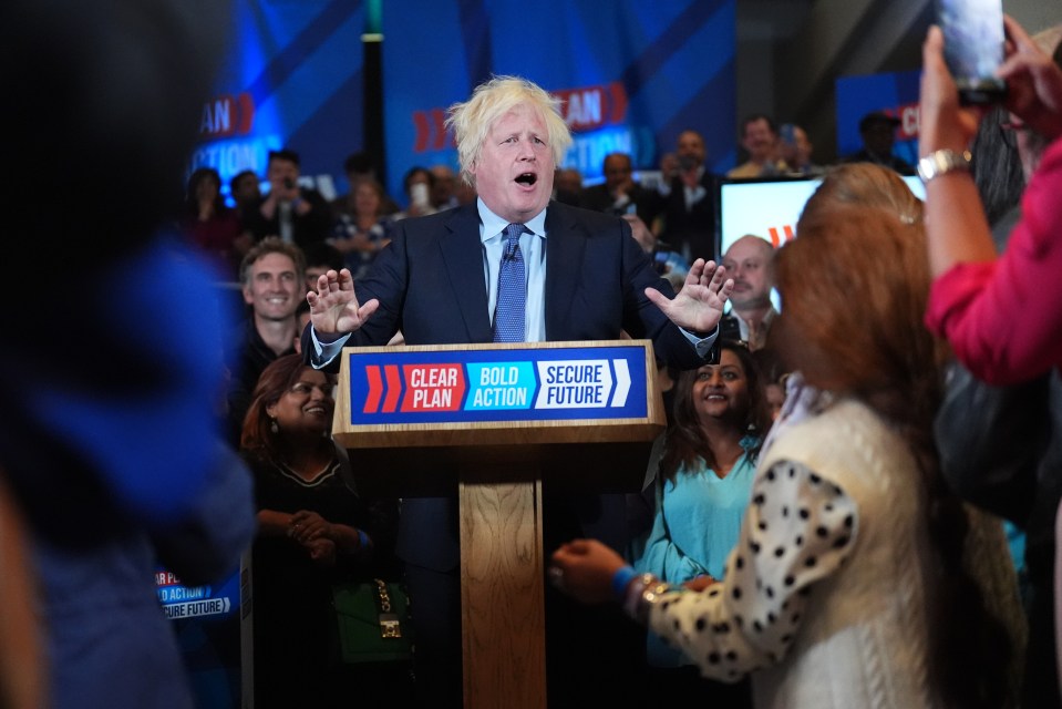 a man stands at a podium that says clear play bold action secure future