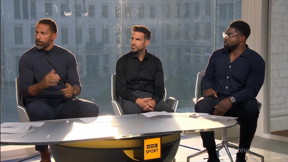 three men sit at a table with a yellow sign that says bbc sport