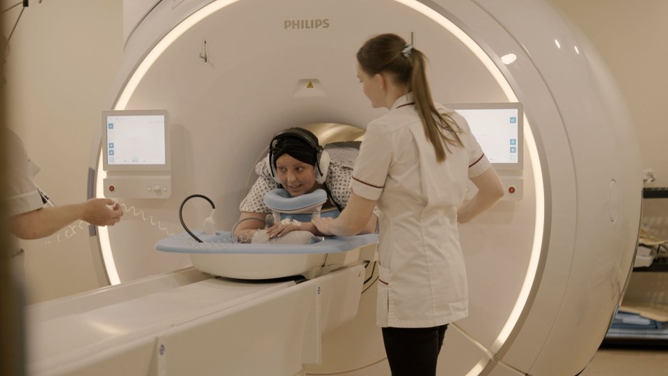 a woman sits in a philips mri machine