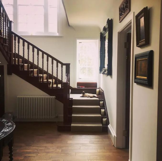 a staircase with candles on the steps and a mirror on the wall