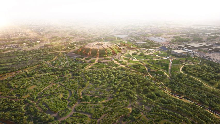 Aerial view of a futuristic World Cup stadium surrounded by landscaped gardens.