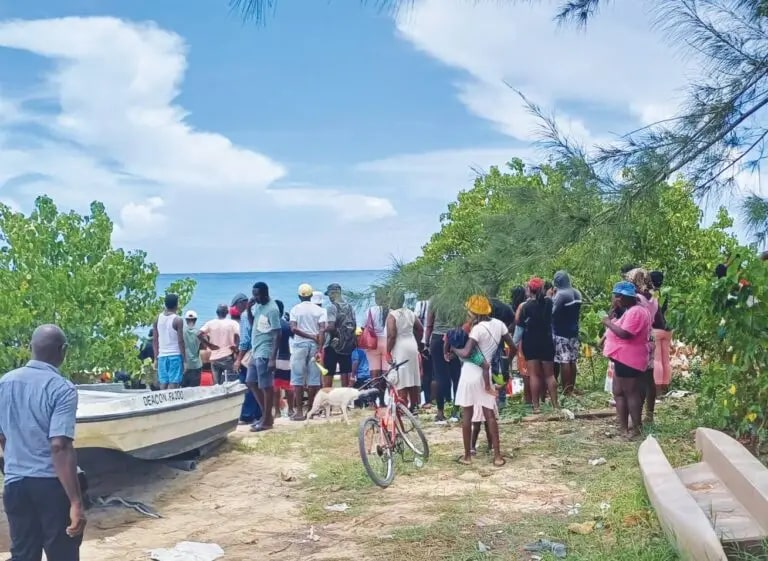 a group of people standing around a boat that says ferdinand