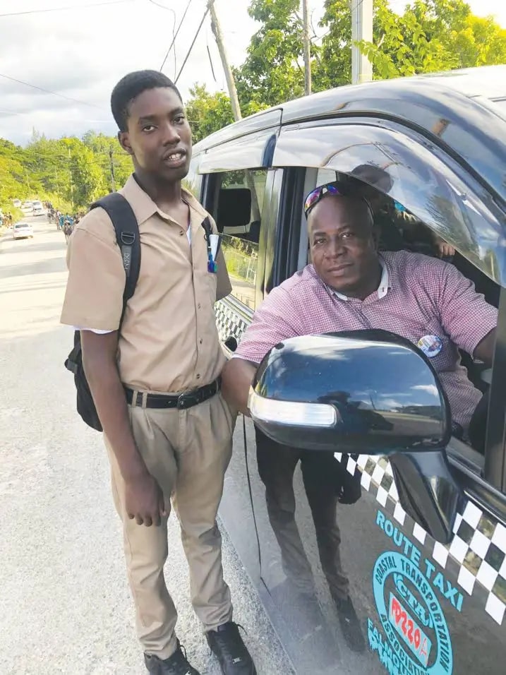 a man standing next to a taxi that says route taxi