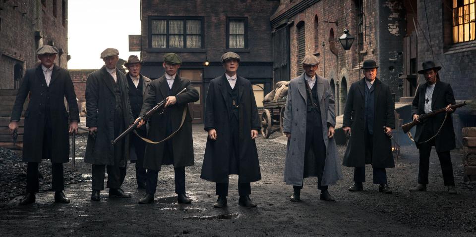 a group of men standing next to each other on a street