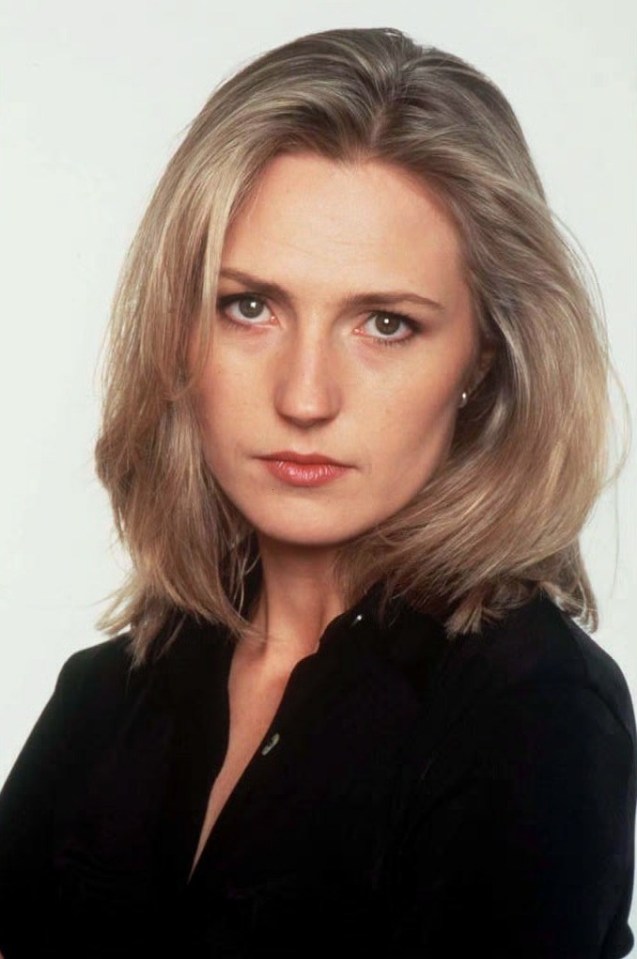 a woman in a black shirt is looking at the camera