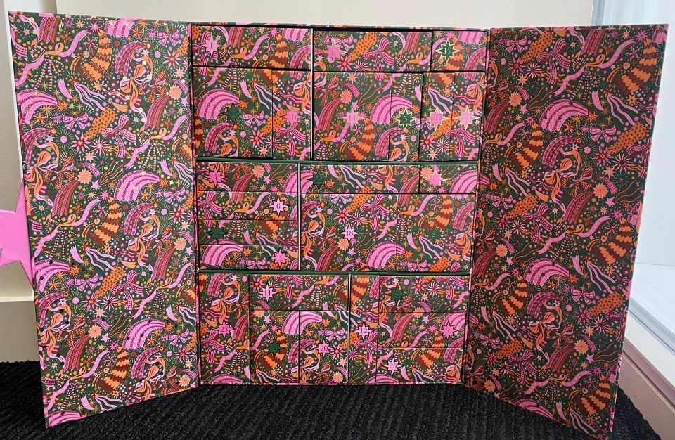 a pink and green box with a floral pattern on it