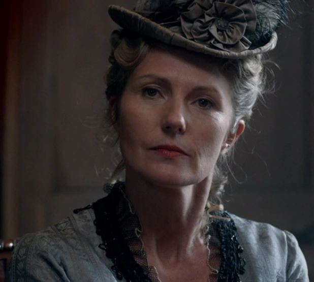 a woman wearing a hat with a flower on it