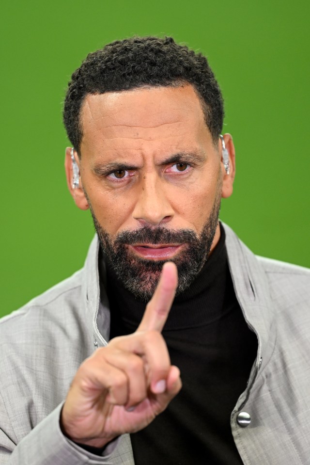 a man with a beard is pointing his finger at the camera