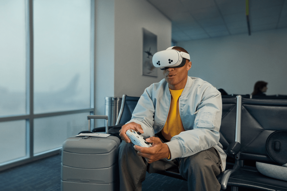 a man wearing a virtual reality headset is playing a video game