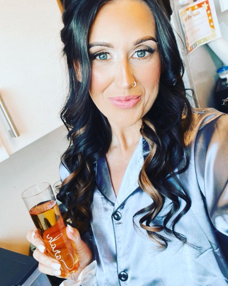 a woman holding a glass with the name olivia on it