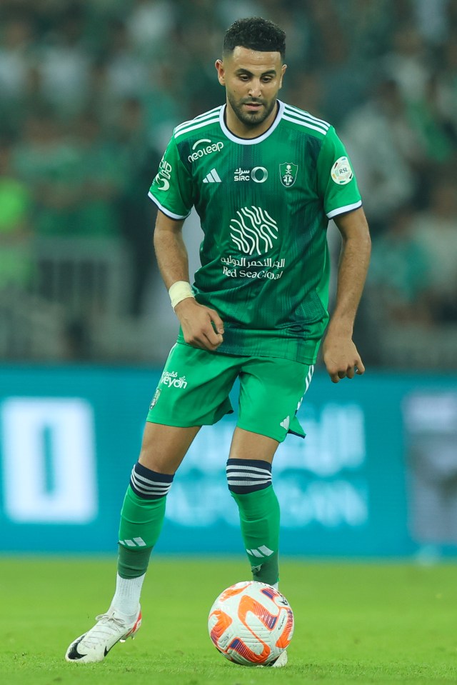a soccer player wearing a green adidas jersey