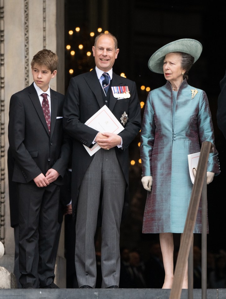 a man in a suit has a medal on his chest