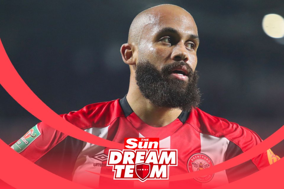 a man with a beard wears a red and white jersey that says the sun dream team