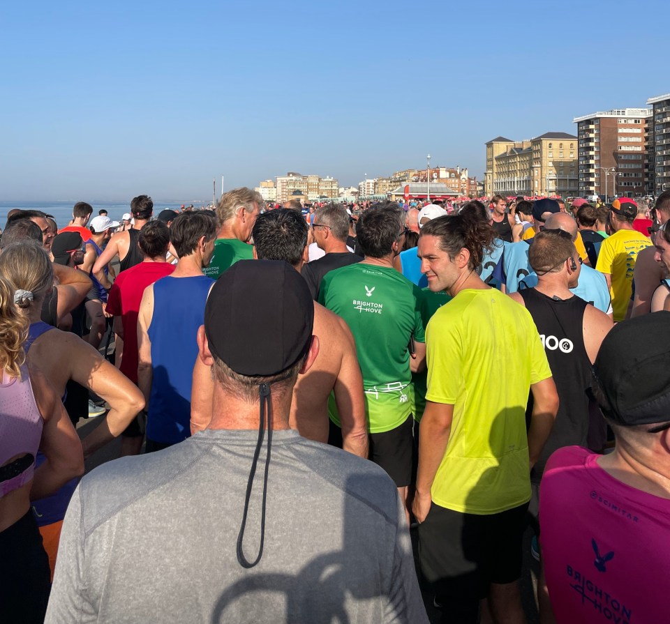 a group of people are gathered in a line wearing brighton marathon shirts