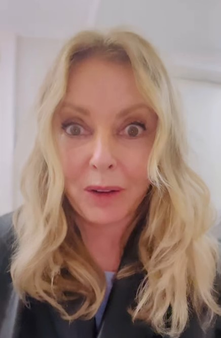 a close up of a woman 's face with a surprised look on her face .