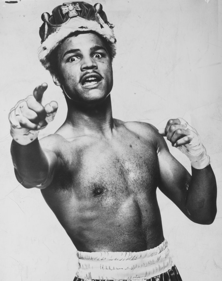 a boxer wearing a crown pointing at the camera