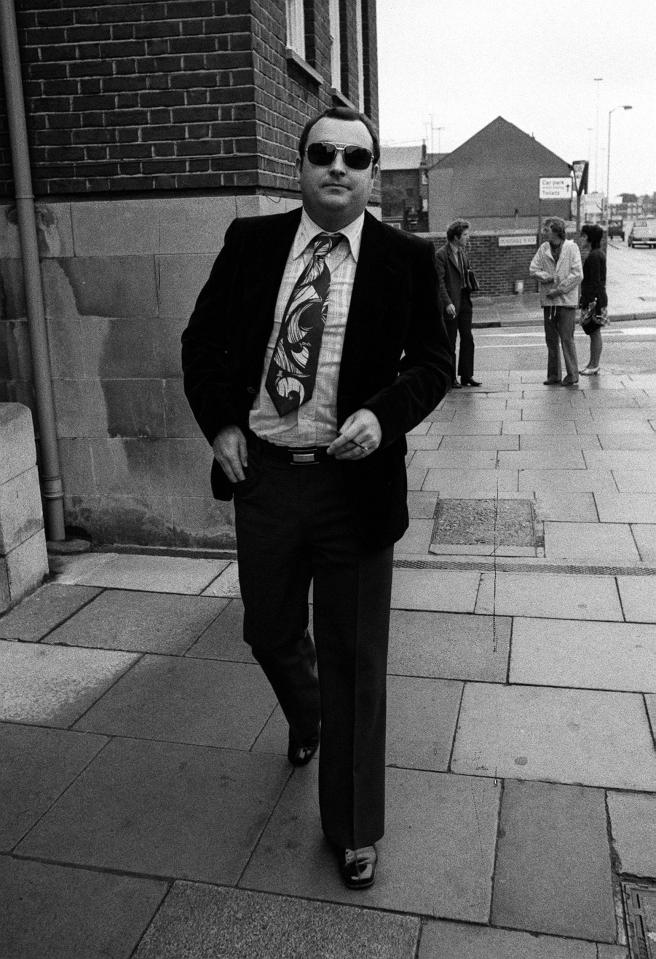 a black and white photo of a man wearing sunglasses