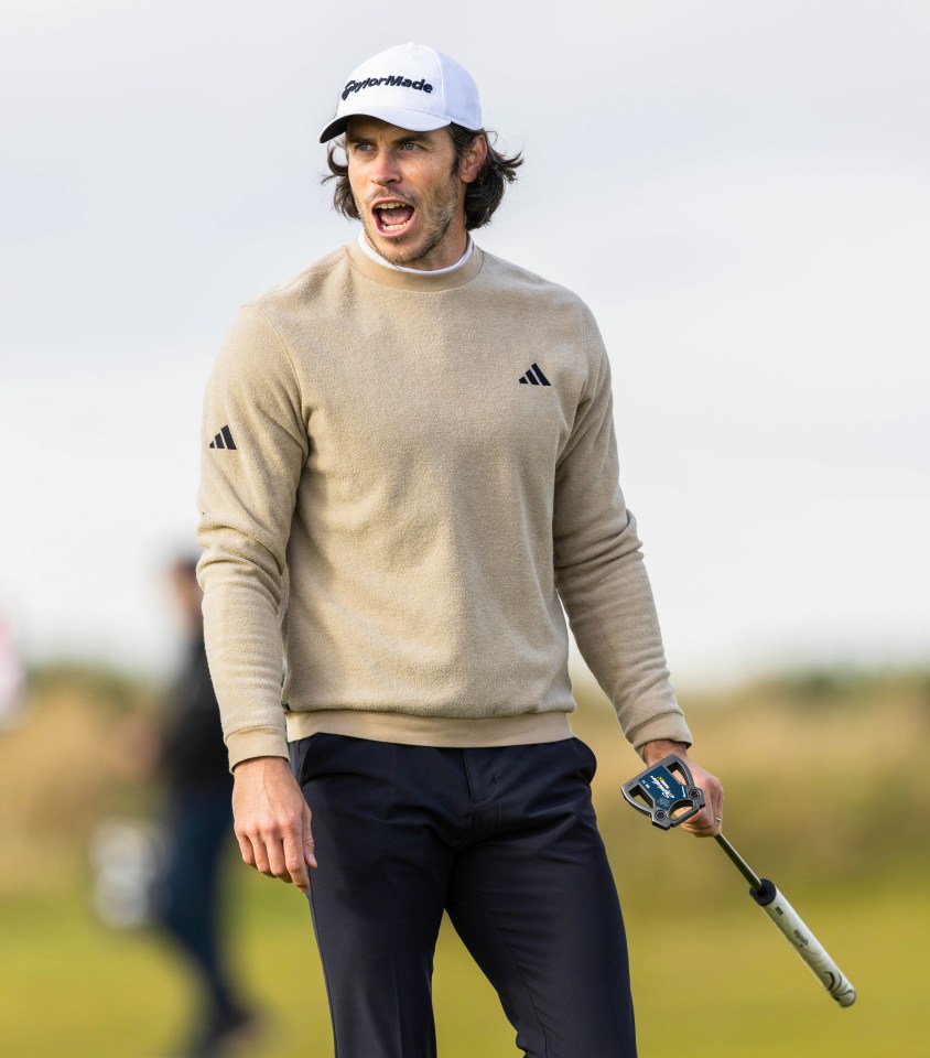 a man wearing a taylormade hat holds a golf club