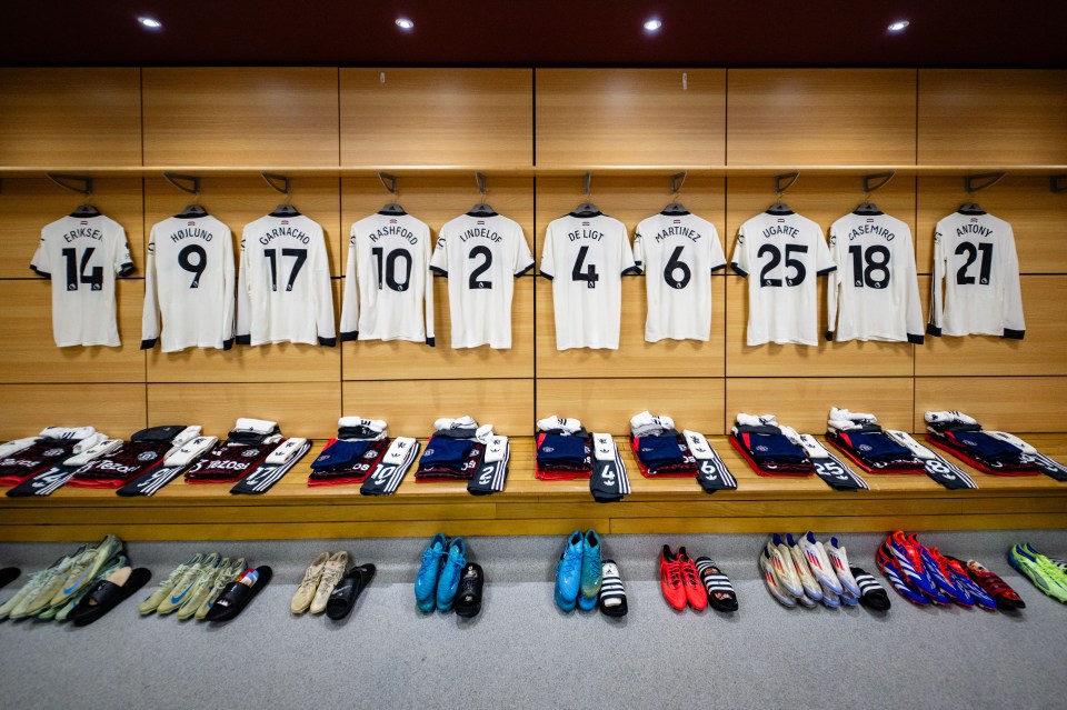 a locker room with jerseys hanging on the wall including number 14