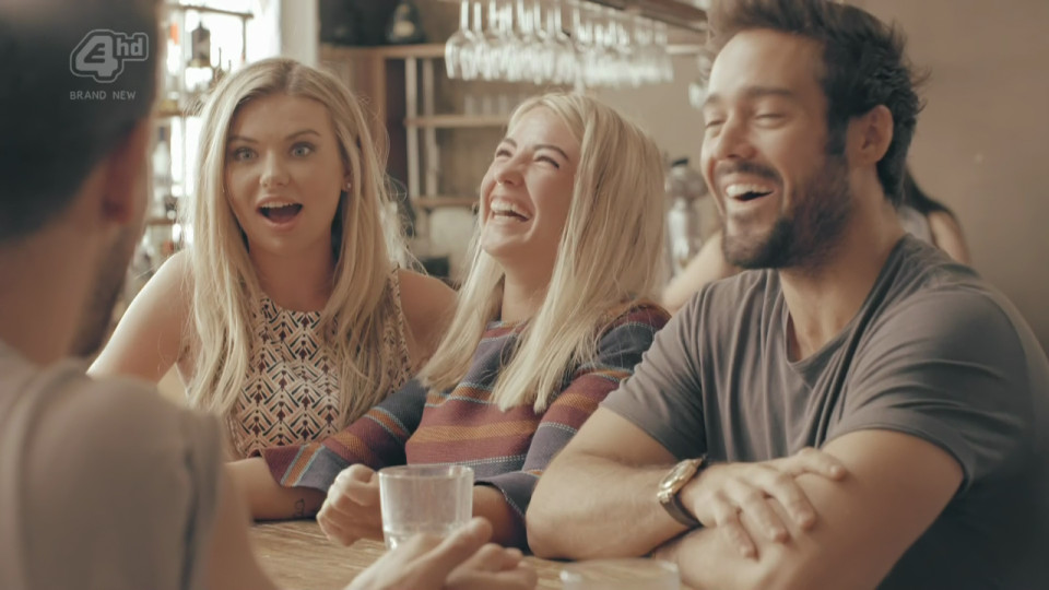 a group of people are sitting at a table with 4 hd written on the bottom