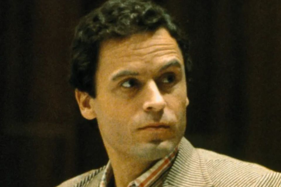 a close up of a man 's face with a striped jacket on