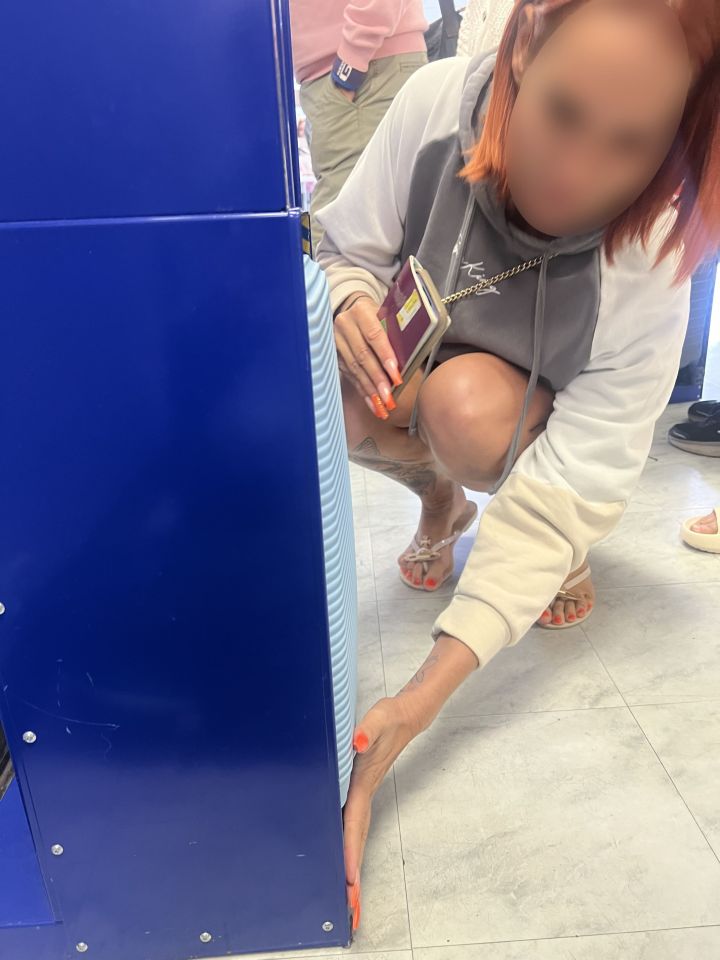 a woman with red hair and a hoodie that says reebok on it