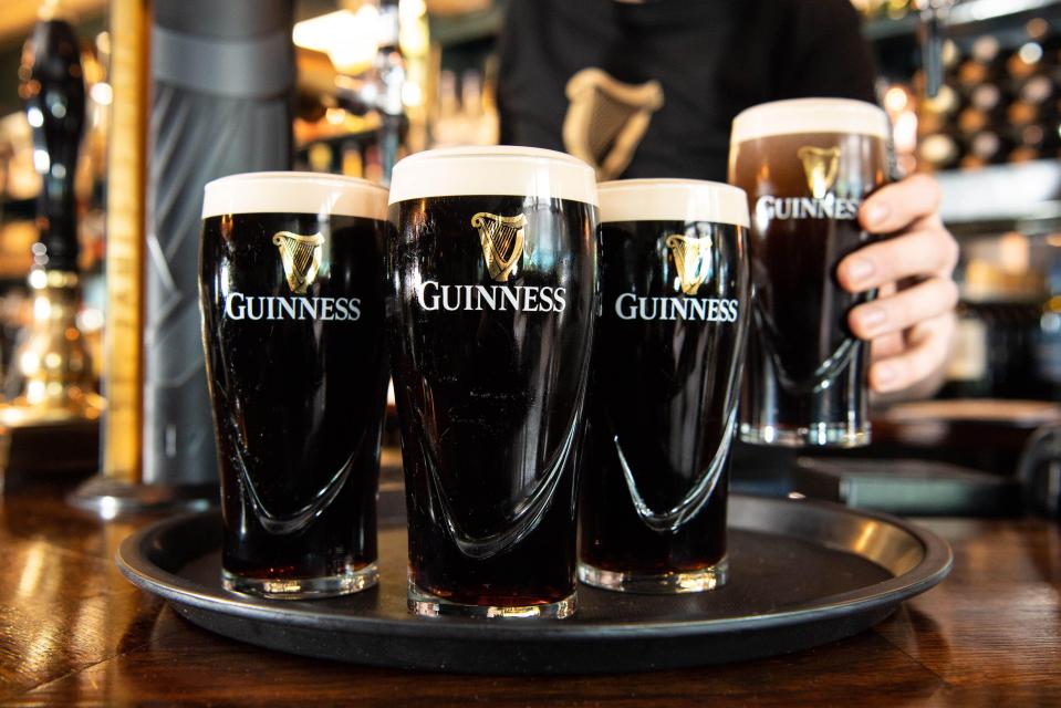 Four pints of Guinness on a tray.
