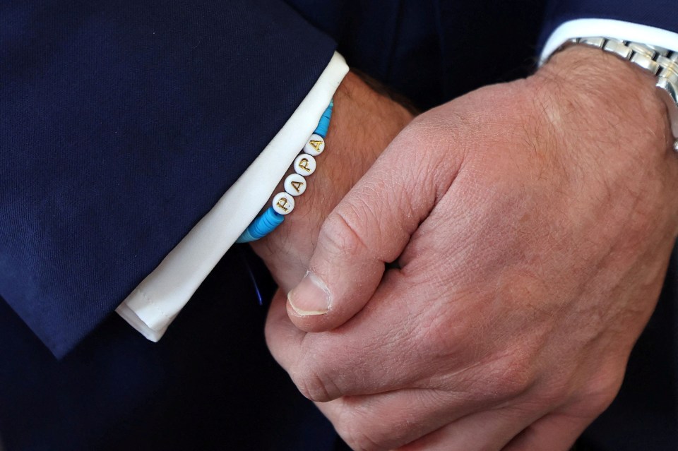 a man wearing a papa bracelet on his wrist