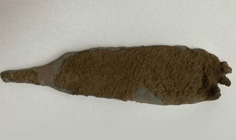 a piece of clay is sitting on a white surface