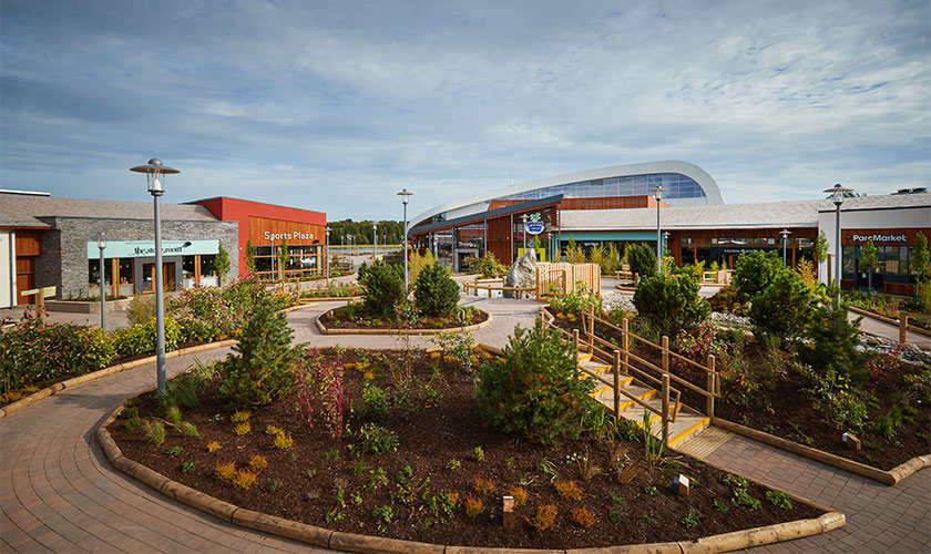 a sports plaza is located in the middle of a park